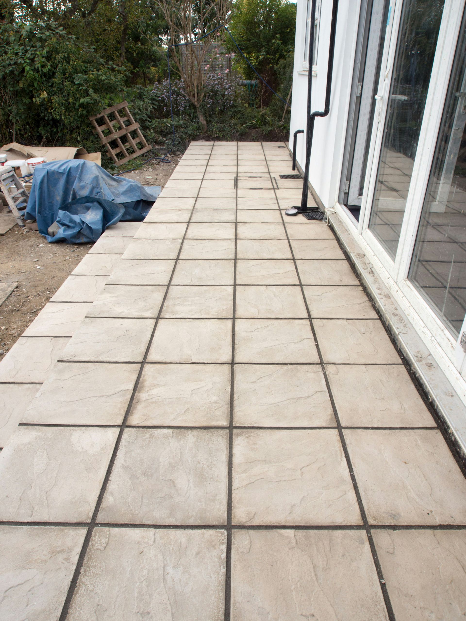 Newly installed paving stones outside a building.